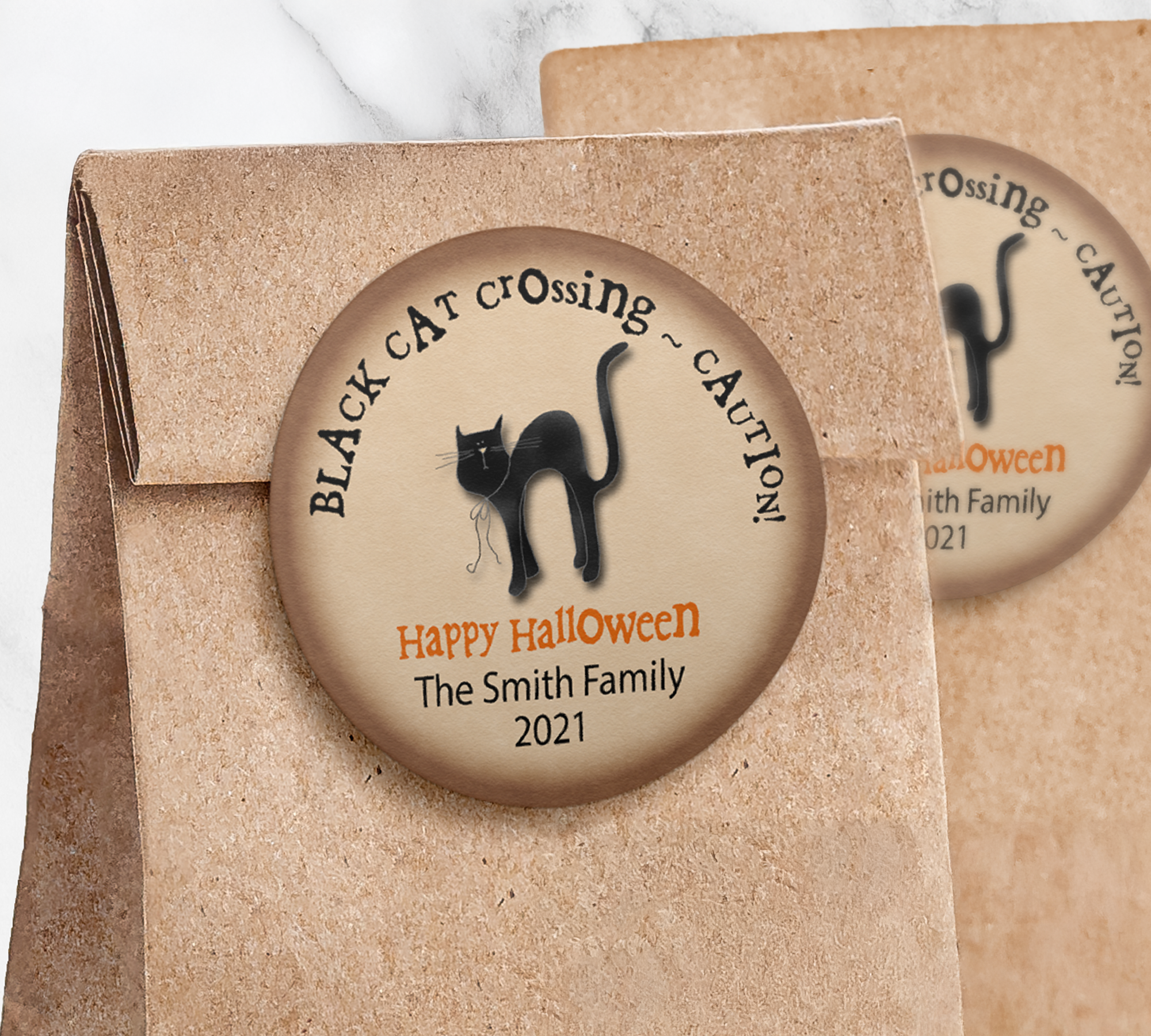 Round black cat sticker with brown background on paper trick or treat bag