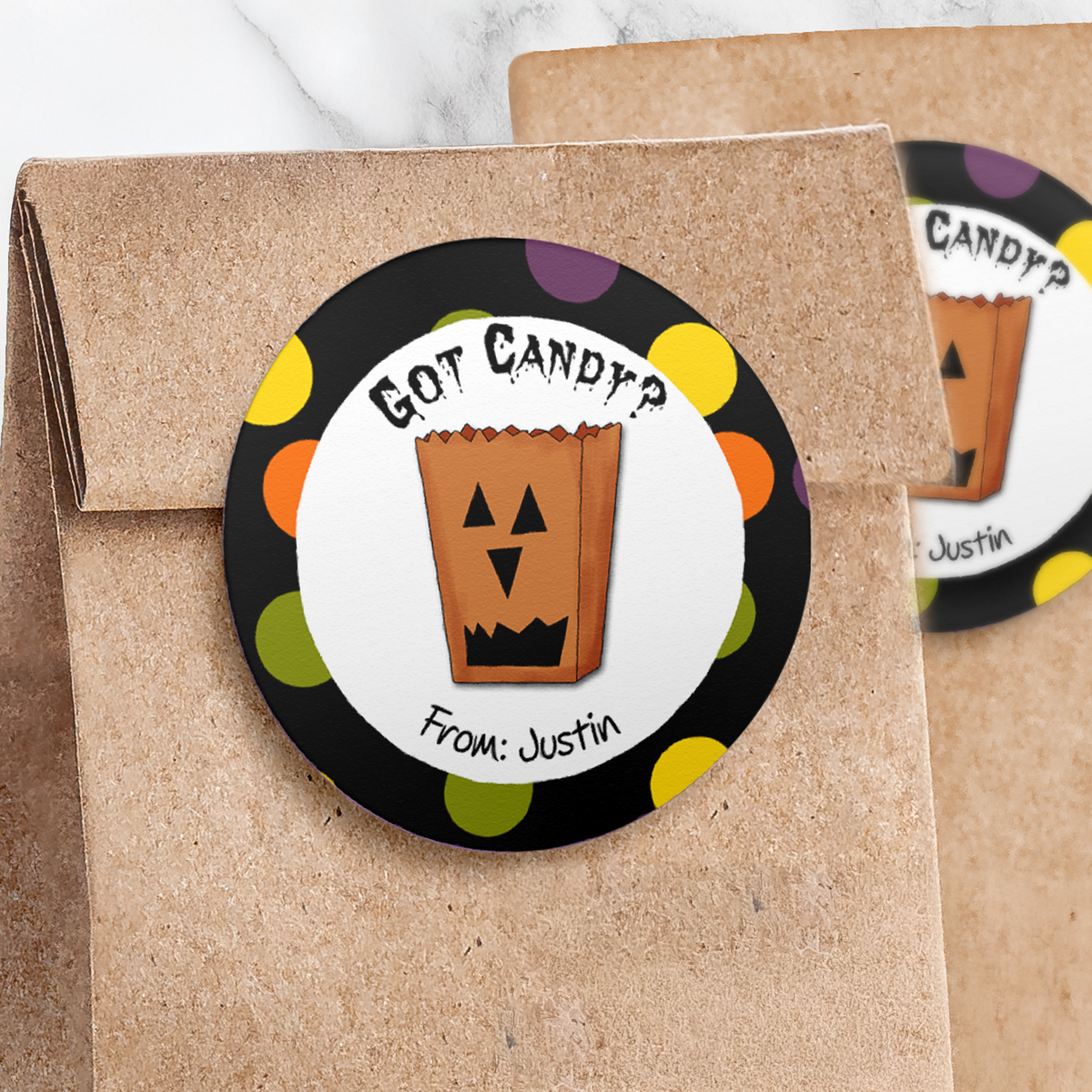 Round treat bag sticker with black dotted border on paper trick or treat bag