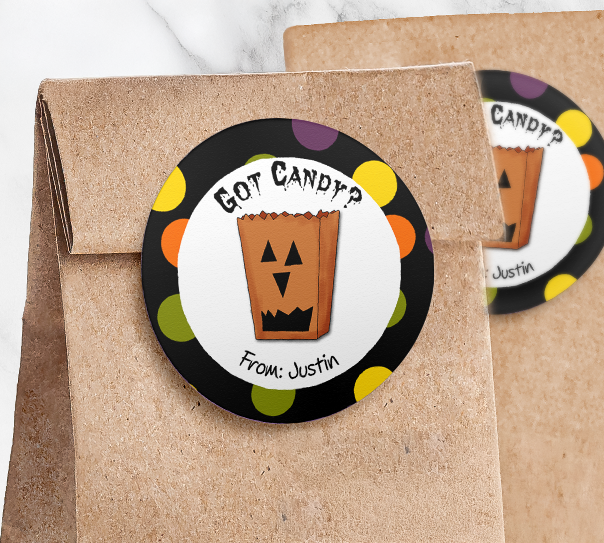 Round treat bag sticker with black dotted border on paper trick or treat bag