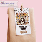 Halloween-themed treat bag with a cow costume design and 'Trick or Treat Caleb' text, attached to a pink background.