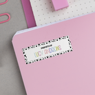 Spotted Border Name Stickers on back of pink notebook